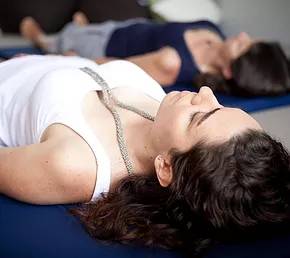 Woman lying down doing breathwork