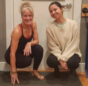 Photo of Suzanna Hasnay and Haley Bonilla kneeling together and smiling.
